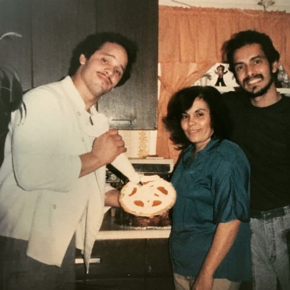 William Rivera in a kitchen with family