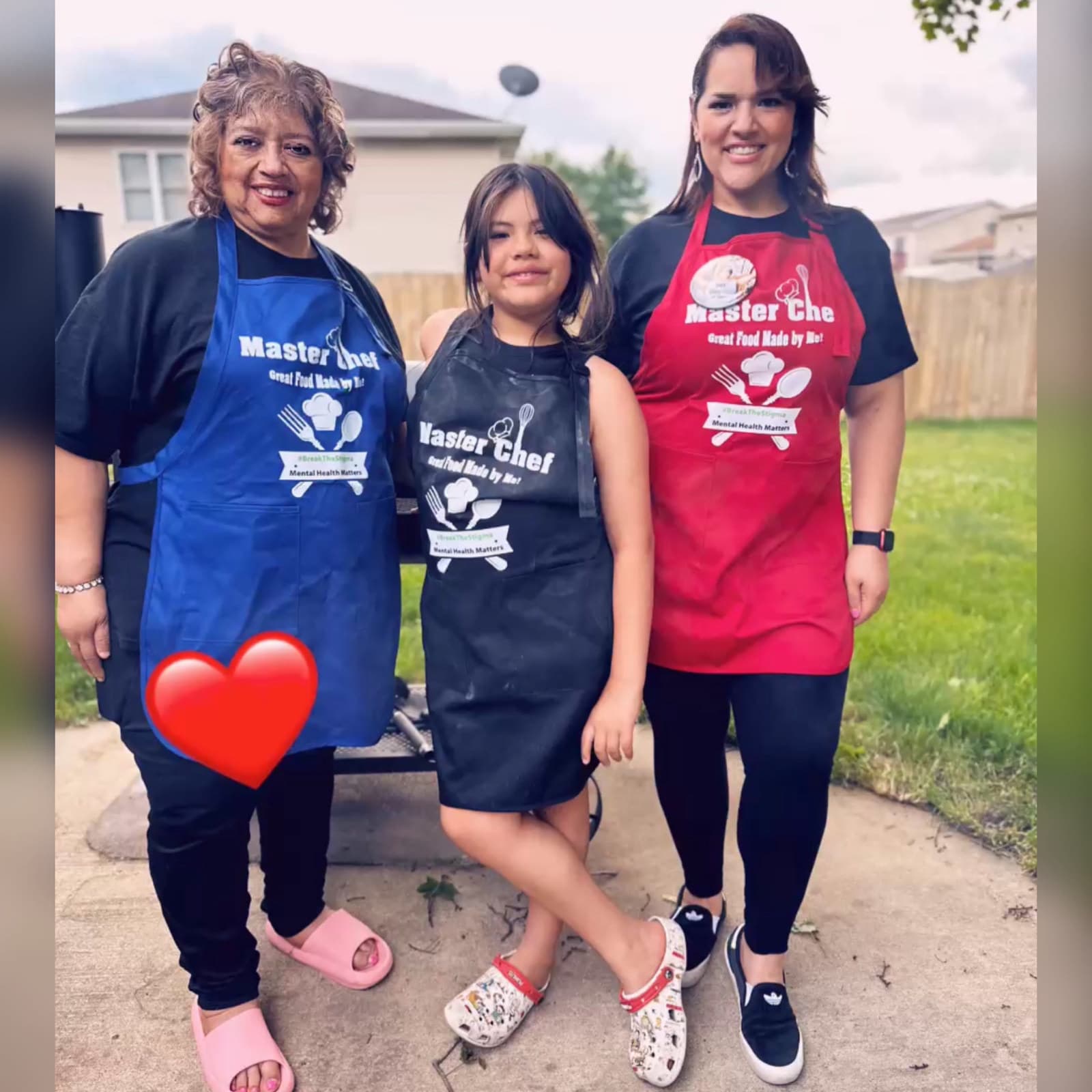 Three family members wearing Master Chef aprons