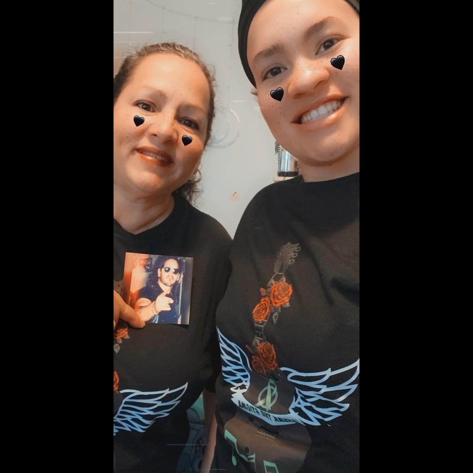 Two people in winged-guitar tees